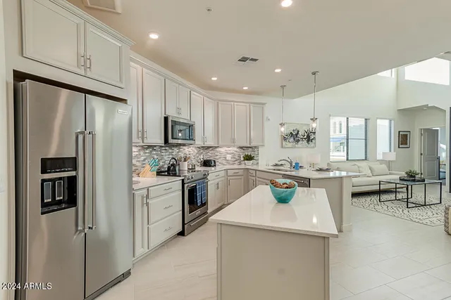 a kitchen with a sink stainless steel appliances and white cabinets