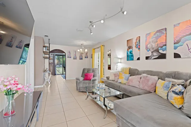 a living room with furniture and flowers