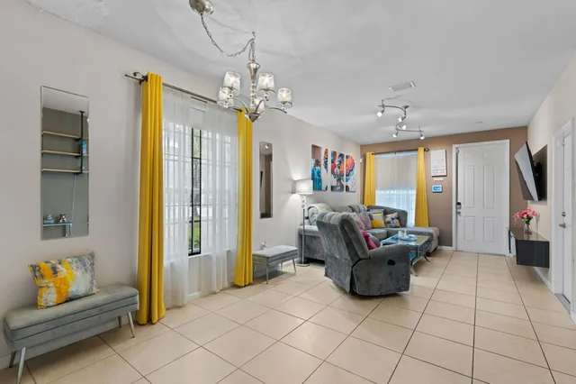 a living room with furniture and a chandelier