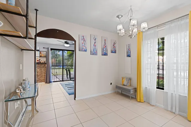 a spacious bathroom with a mirror a bathtub and a shower