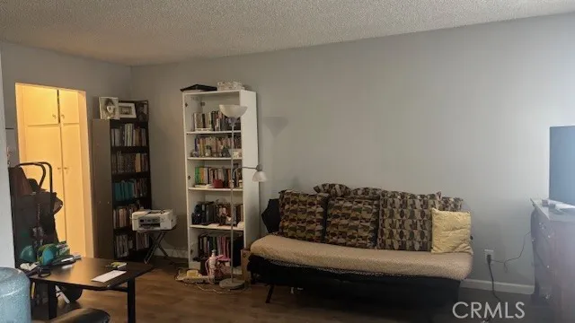 a living room with furniture a flat screen tv and a window