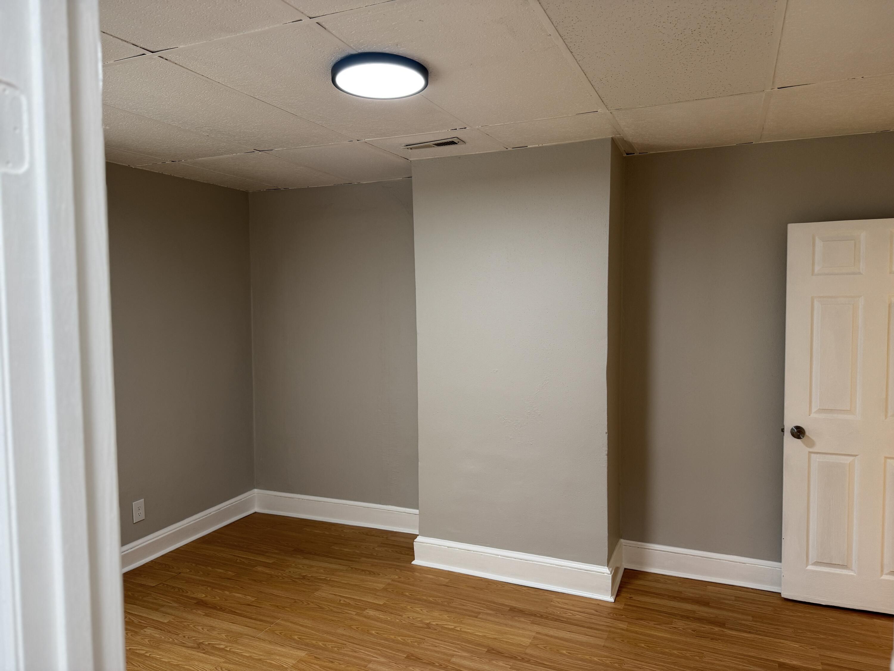 1006 Halifax Road Danville, VA 24540 - Photo 5 of 7 a view of an empty room with wooden floor