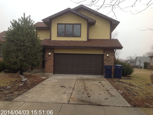 151 White Oaks Road Matteson, IL 60443 - Photo 1 of 12 a front view of a house with a yard and garage
