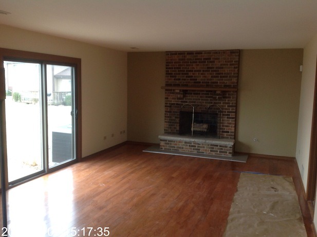 151 White Oaks Road Matteson, IL 60443 - Photo 3 of 12 a view of an empty room with wooden floor and a window