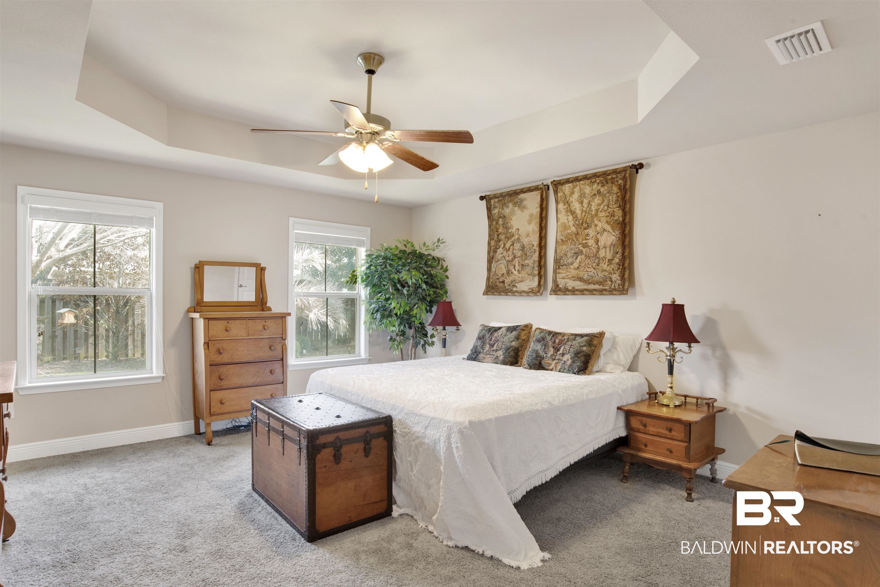 22056 Garland Loop Silverhill, AL 36576 - Photo 13 of 28 Bedroom with a tray ceiling, baseboards, ceiling fan, visible vents, and light carpet