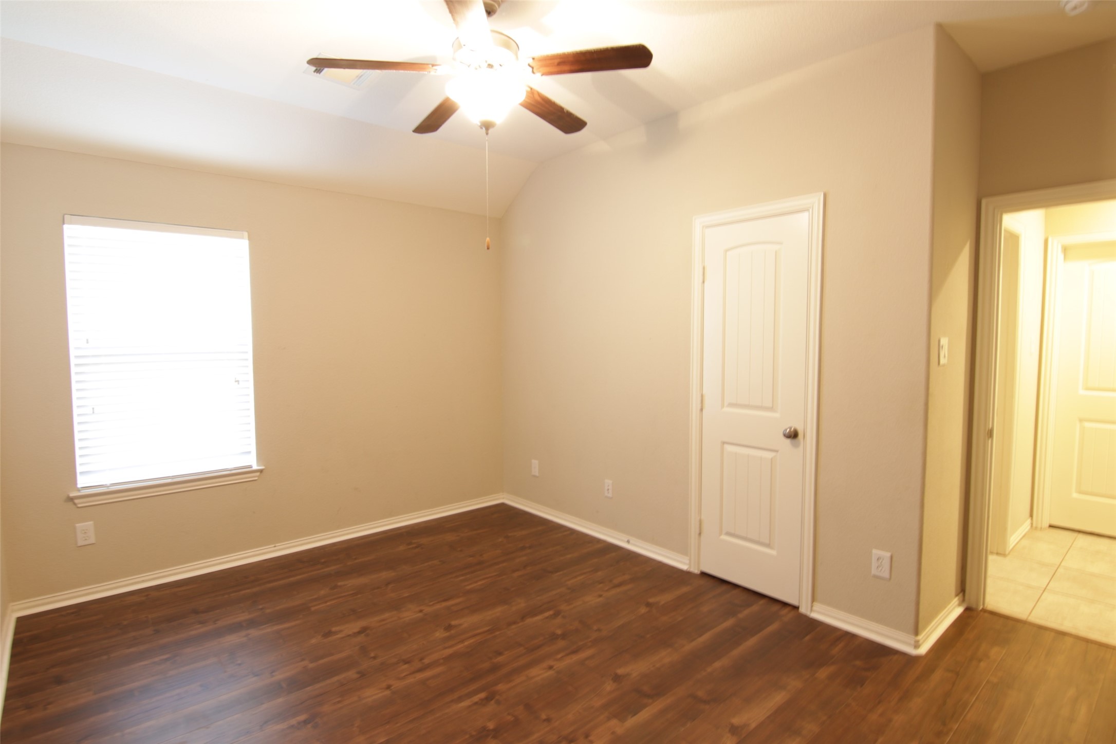 6719 Rambling Manor Court Richmond, TX 77469 - Photo 19 of 26 a view of an empty room with wooden floor and a window