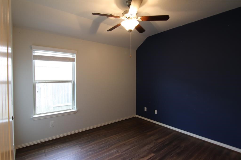 6719 Rambling Manor Court Richmond, TX 77469 - Photo 20 of 26 a view of an empty room with window and wooden floor