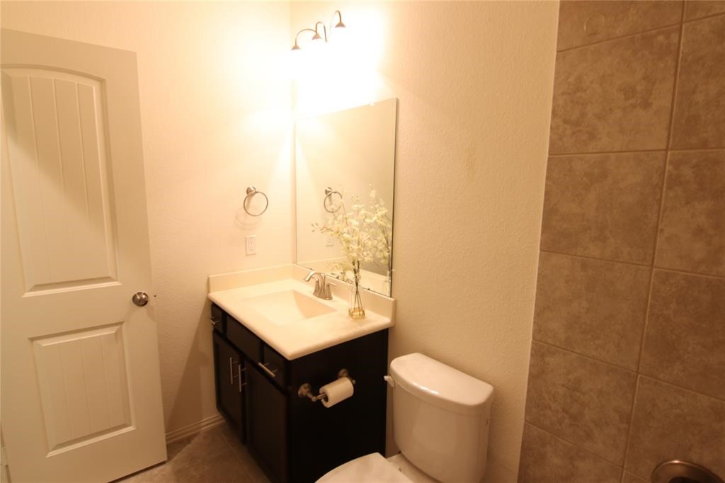 6719 Rambling Manor Court Richmond, TX 77469 - Photo 22 of 26 a bathroom with a sink a toilet and mirror