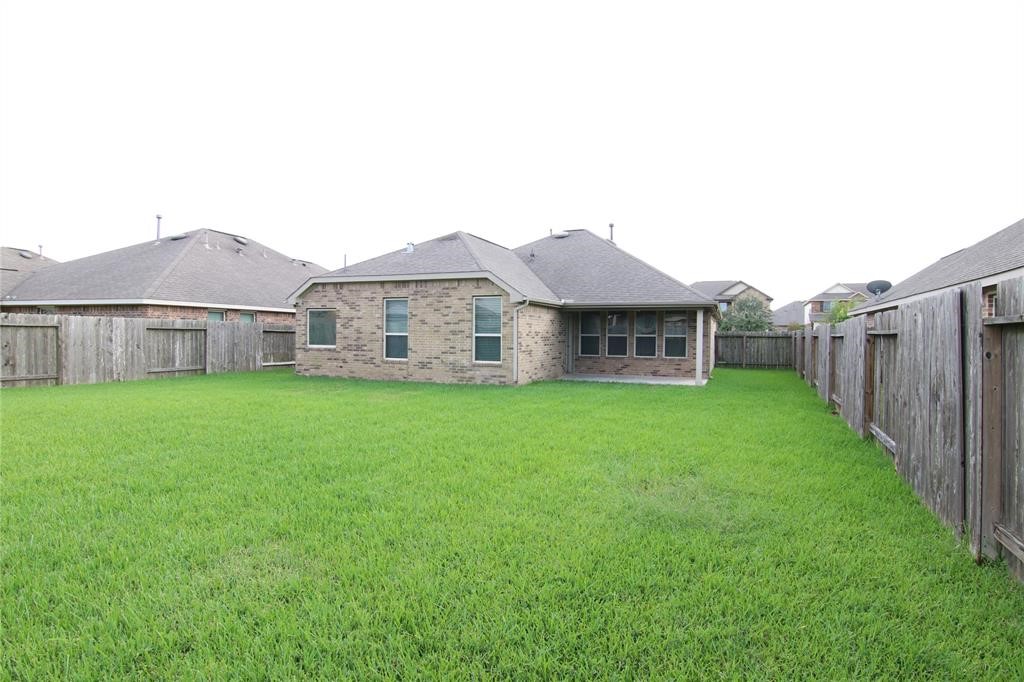6719 Rambling Manor Court Richmond, TX 77469 - Photo 24 of 26 a view of a house with a yard and sitting area