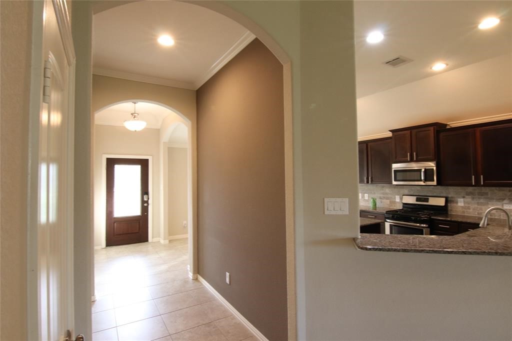 6719 Rambling Manor Court Richmond, TX 77469 - Photo 4 of 26 a view of a kitchen from a corridor