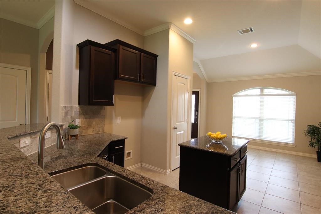 6719 Rambling Manor Court Richmond, TX 77469 - Photo 7 of 26 a kitchen with a sink and a stove top oven with wooden floor
