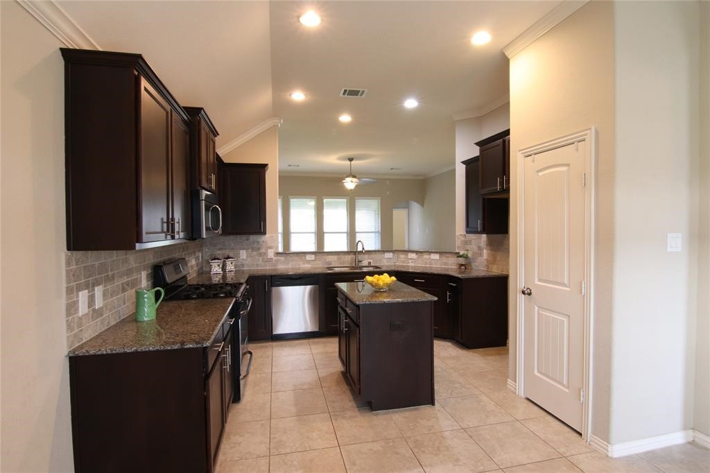 6719 Rambling Manor Court Richmond, TX 77469 - Photo 8 of 26 a kitchen with a sink and a refrigerator