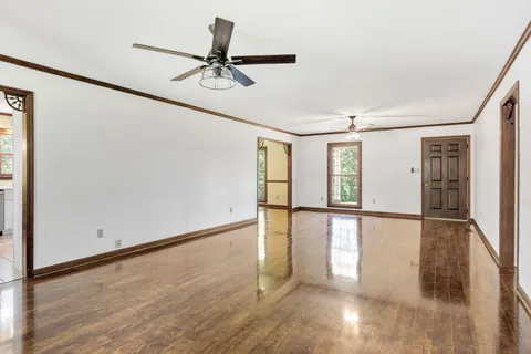a view of a room with wooden floor and white walls