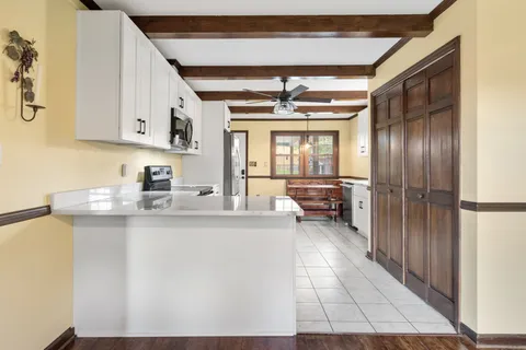 a kitchen with stainless steel appliances granite countertop a sink and cabinets