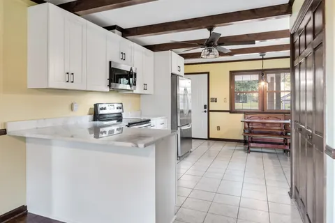 a kitchen with stainless steel appliances a stove a sink and a refrigerator