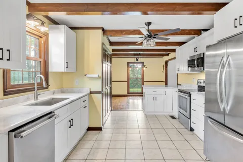 a kitchen with stainless steel appliances granite countertop a sink and cabinets