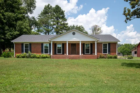front view of a house with a garden