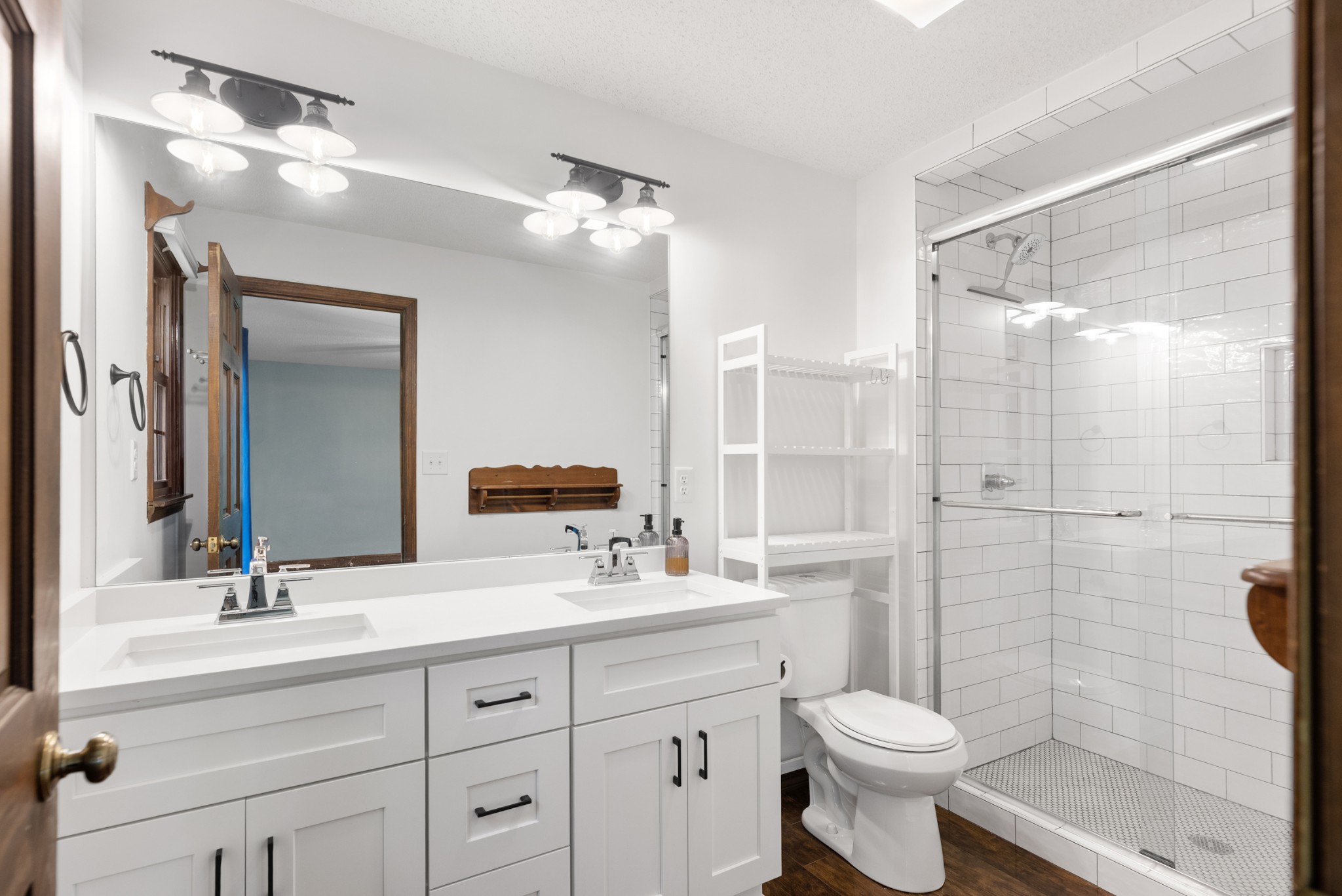 719 Waco Road Lynnville, TN 38472 - Photo 25 of 67 a bathroom with a double vanity sink toilet mirror and shower