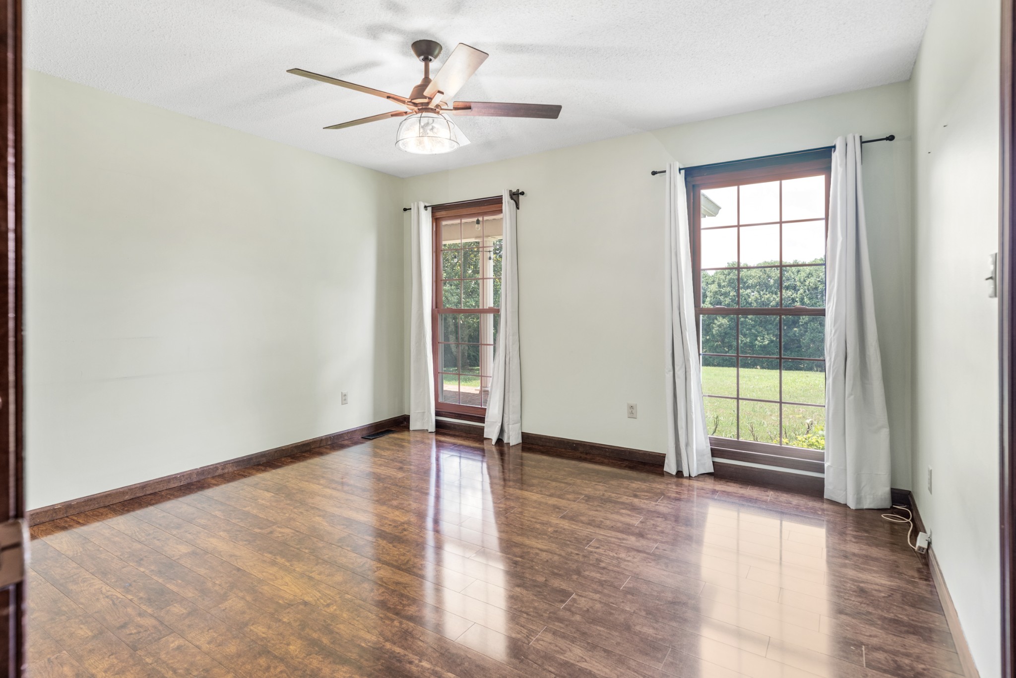 719 Waco Road Lynnville, TN 38472 - Photo 29 of 67 an empty room with wooden floor and windows