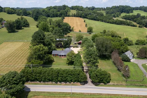 an aerial view of a house with a yard and lake view