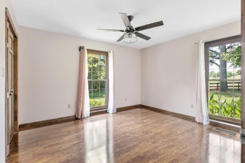 a bedroom with a bed and a chandelier fan