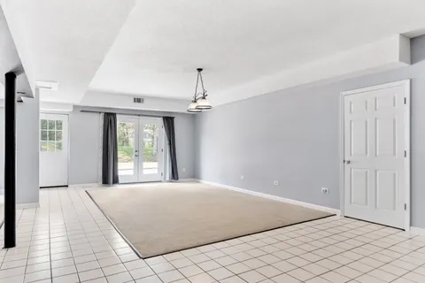 a bed sitting in a room next to a window