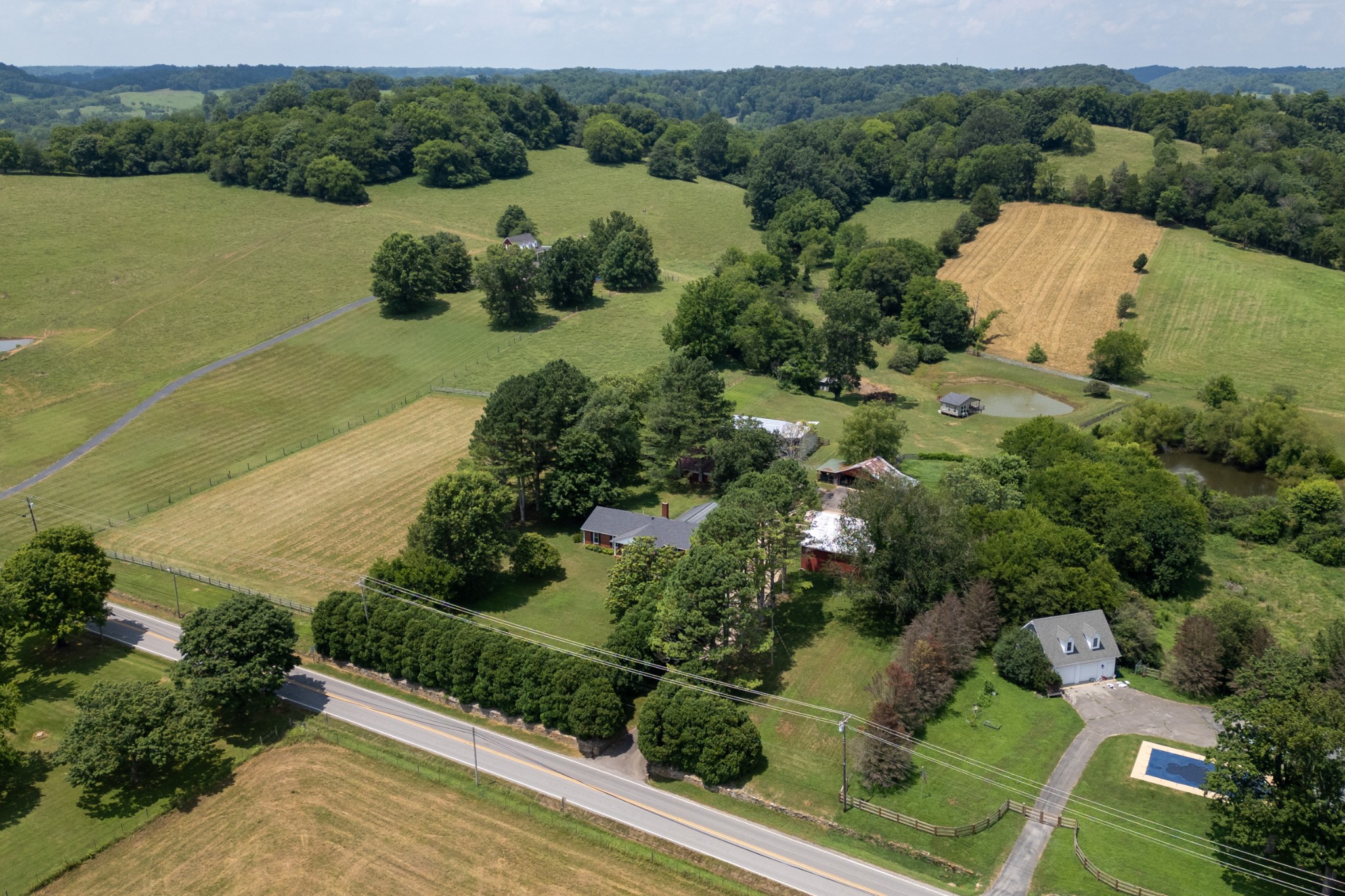 719 Waco Road Lynnville, TN 38472 - Photo 4 of 67 an aerial view of green landscape with trees houses and lake view