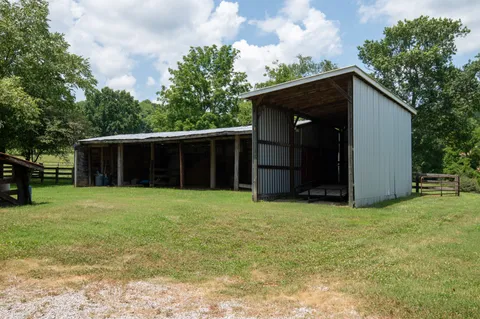 an aerial view of a house with outdoor space and a lake view
