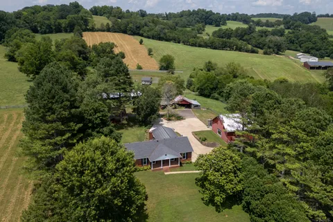 an aerial view of house with yard and lake view