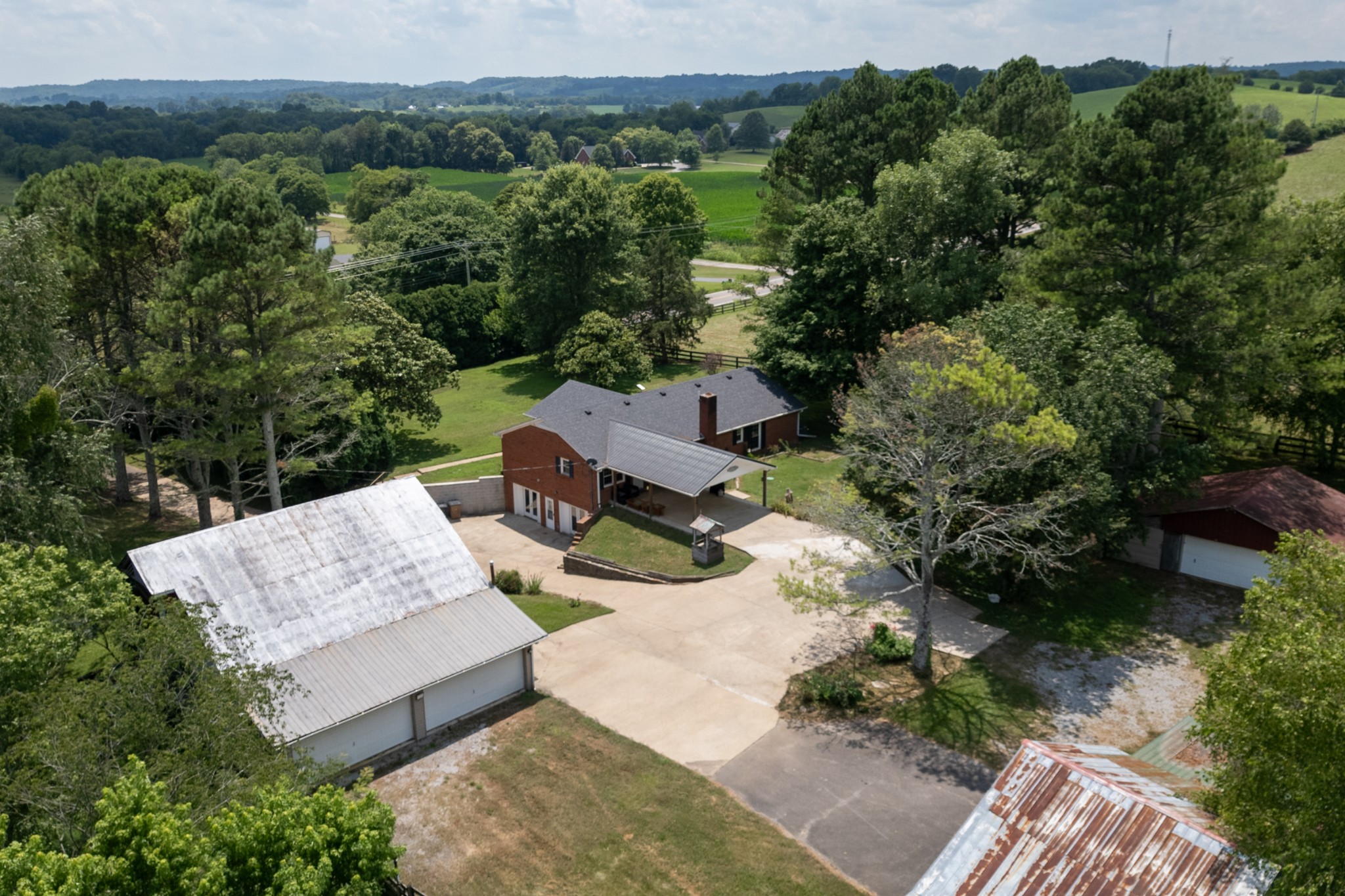 719 Waco Road Lynnville, TN 38472 - Photo 55 of 67 an aerial view of a house with pool plants and large trees
