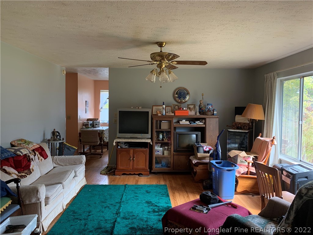 350 Horseshoe Road Aberdeen, NC 28315 - Photo 11 of 47 a living room with furniture a window and a flat screen tv