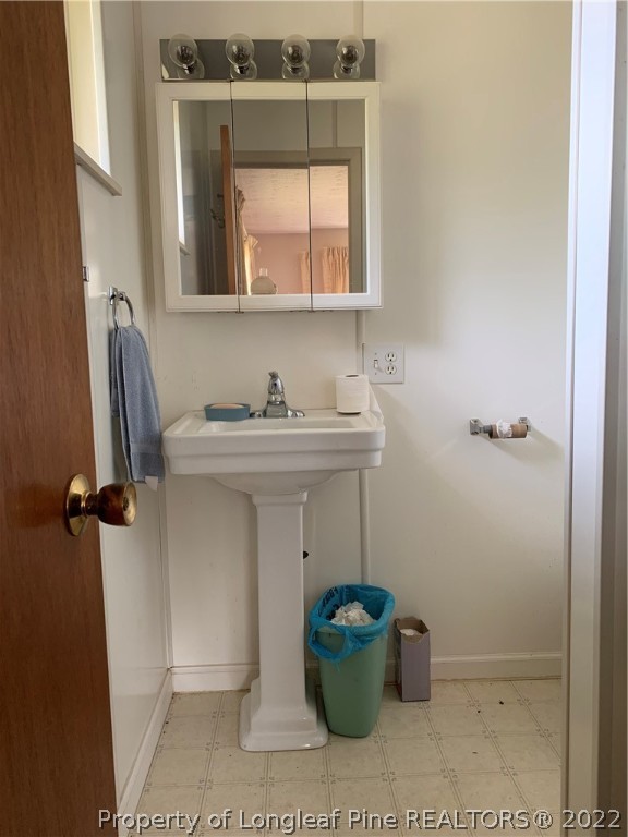 350 Horseshoe Road Aberdeen, NC 28315 - Photo 28 of 47 a bathroom with a sink and a window