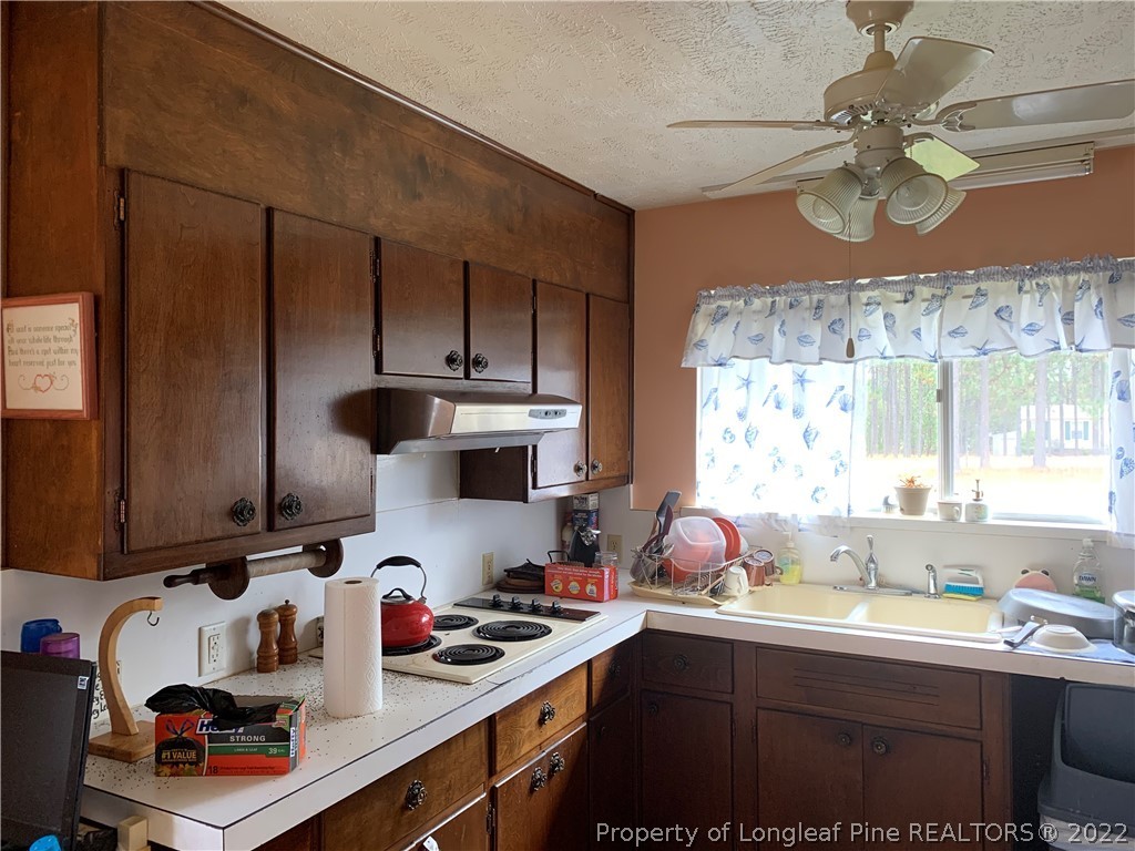 350 Horseshoe Road Aberdeen, NC 28315 - Photo 7 of 47 a kitchen with a sink cabinets and window
