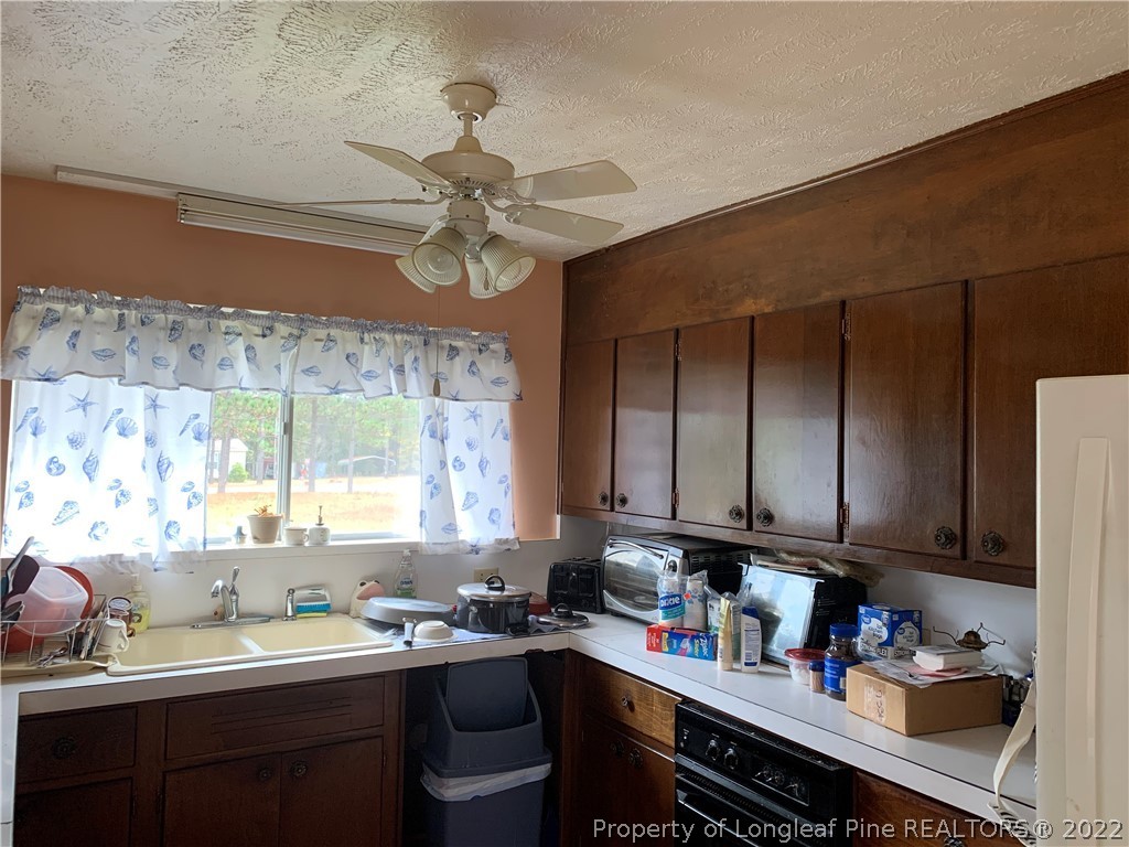 350 Horseshoe Road Aberdeen, NC 28315 - Photo 8 of 47 a kitchen with a sink cabinets and window