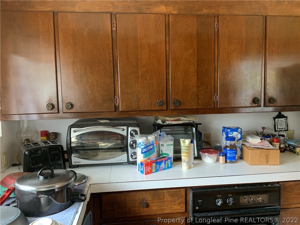350 Horseshoe Road Aberdeen, NC 28315 - Photo 10 of 47 a kitchen with a refrigerator and a stove