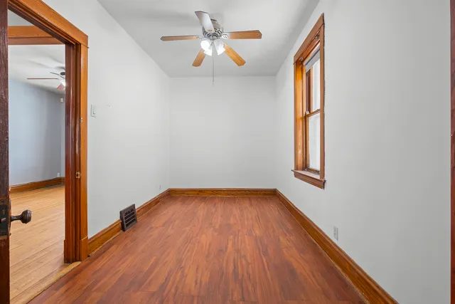 wooden floor in an empty room with a window