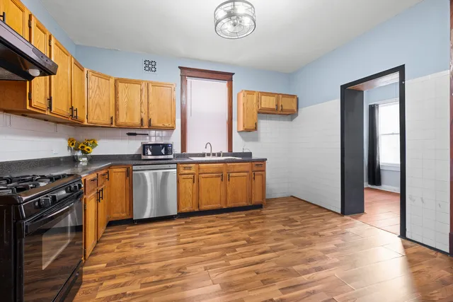 a kitchen with a stove a sink and a refrigerator