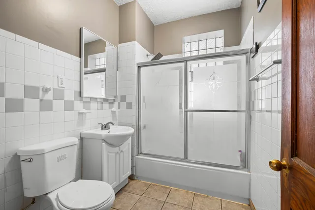 a white toilet sitting next to a bathroom sink