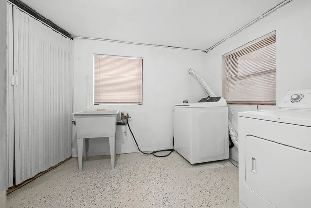 a backyard of a house with table and chairs