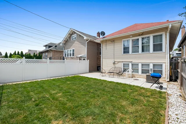 an aerial view of residential houses with outdoor space and parking