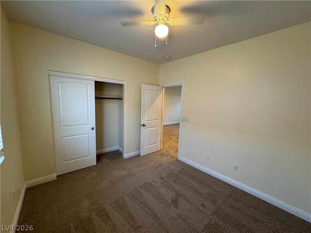 1333 Jamesbury Road Las Vegas, NV 89135 - Photo 29 of 43 Comfortable bedroom with soft carpet flooring and convenient sliding closet doors.