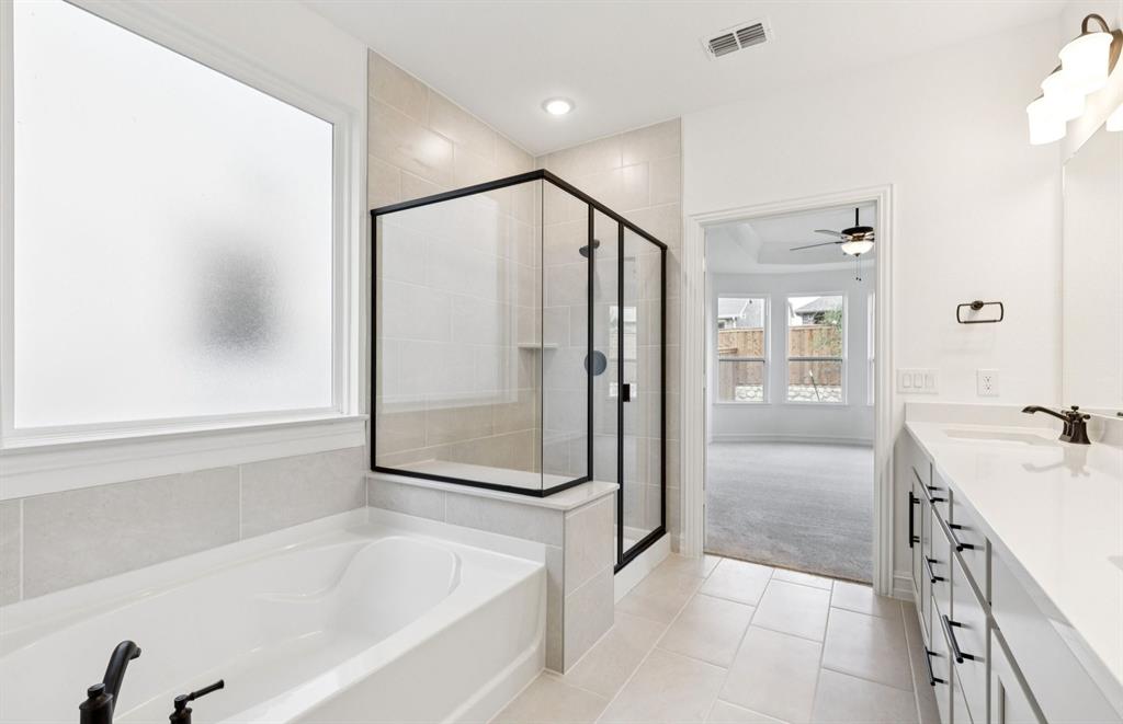 304 Brookhurst Road Little Elm, TX 75068 - Photo 13 of 22 a spacious bathroom with a bathtub and a shower