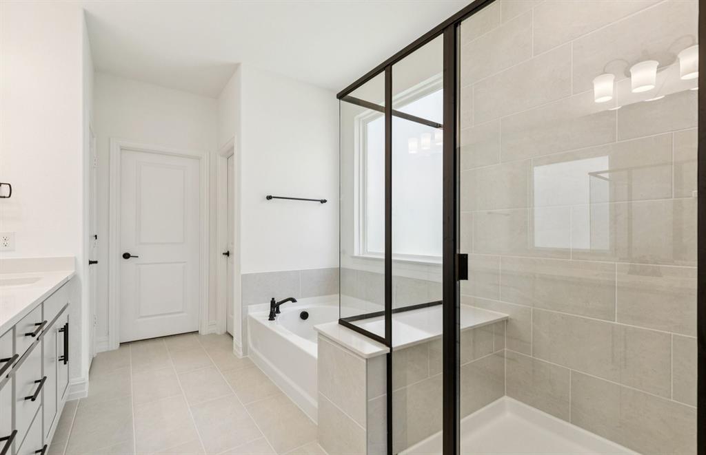 304 Brookhurst Road Little Elm, TX 75068 - Photo 14 of 22 a bathroom with a tub and shower