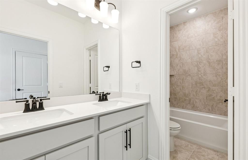 304 Brookhurst Road Little Elm, TX 75068 - Photo 19 of 22 a bathroom with a sink a tub and a mirror