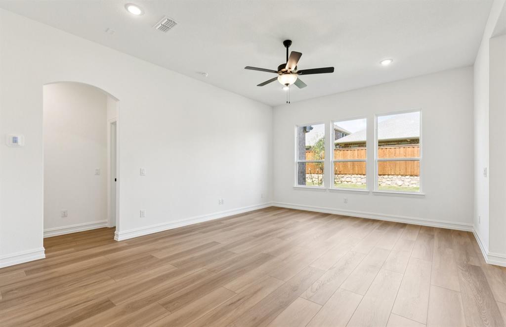 304 Brookhurst Road Little Elm, TX 75068 - Photo 5 of 22 a view of empty room with wooden floor and fan