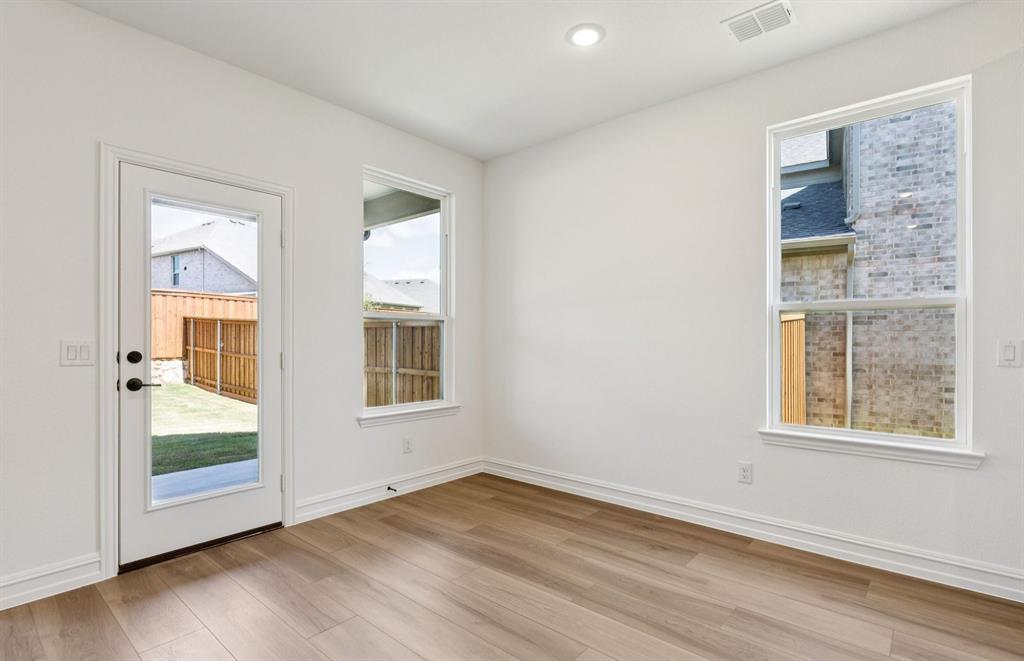 304 Brookhurst Road Little Elm, TX 75068 - Photo 8 of 22 an empty room with wooden floor and windows
