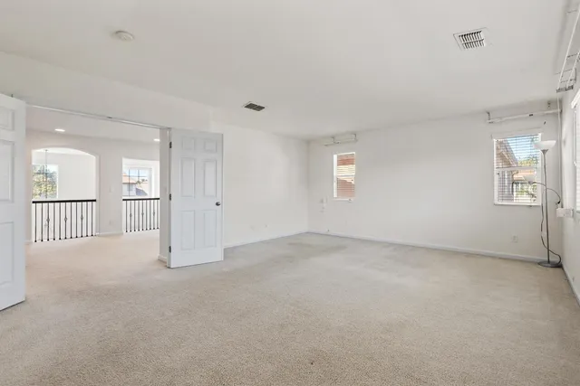 an empty room with windows and entrance