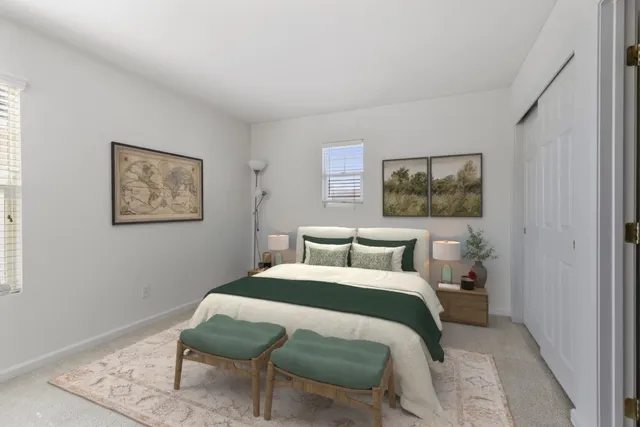 a bedroom with a bed and a painting on the wall