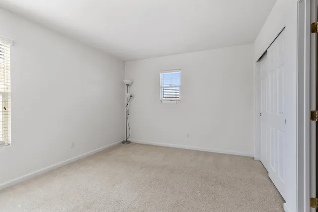 an empty room with a empty space and windows