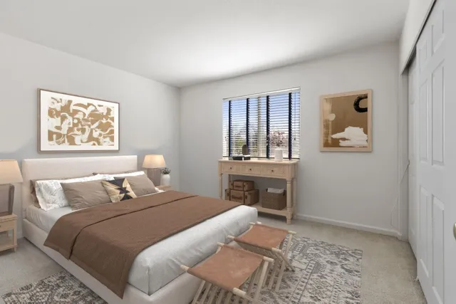 a bedroom with a bed and a painting on the wall